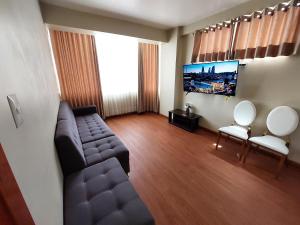 a living room with a couch and a flat screen tv at Marito in Juliaca