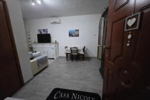a hallway with a living room with a couch and a table at Casa Nicole in Assemini