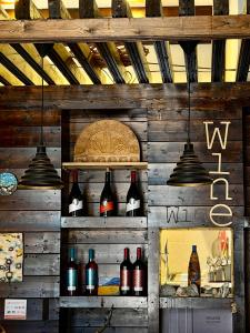 a wall with shelves with wine bottles on it at Art House Mestia in Mestia