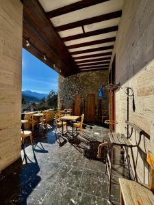 a patio with tables and chairs on a building at Art House Mestia in Mestia