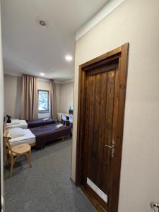 a room with a door leading to a bedroom with a bed at Art House Mestia in Mestia