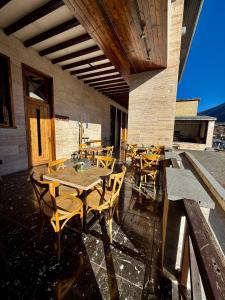 a patio with a table and chairs on a building at Art House Mestia in Mestia +19 photos