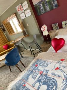 a bedroom with a bed with a heart pillow on it at PuraVida in Westkapelle