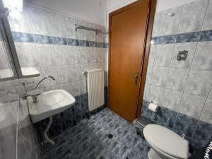 a bathroom with a toilet and a sink at AETIA -TSIOURGIAKA MPATSILAS Group in Aetia +31 photos