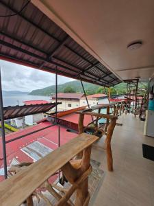 a balcony with a table and a view of the ocean at Aloha Aina Dive Resort in Mabini