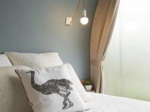 a bedroom with a dinosaur pillow on a bed at ZEcamping 3 étoiles animaux acceptés bar épicerie et restaurant in Auxonne
