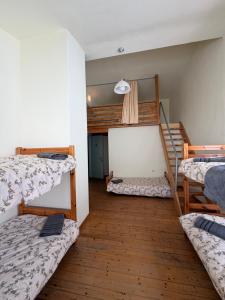 a room with three bunk beds and a staircase at AETIA -TSIOURGIAKA MPATSILAS Group in Aetia
