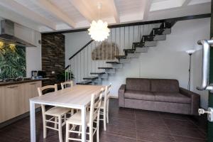a dining room with a table and a couch at Lake-Hot Springs-Gardaland, Private Parking at Dolce Duplex Lazise in Lazise