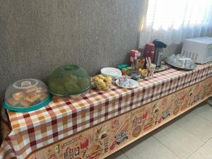 a table with a table cloth with food on it at Hotel Universo in Goiânia