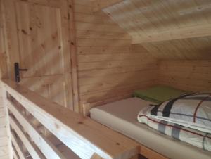 a bedroom in a log cabin with a bed at Perła Brenno in Brenno +53 photos