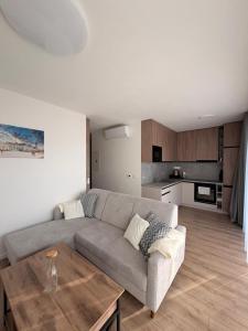 a living room with a couch and a table at Sekvoja view apartment in Nová Baňa