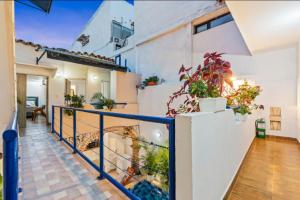 a balcony of a house with potted plants at Casa Payis Hotel in Cartagena de Indias