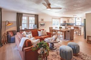 a living room with a couch and a table at Sunset Cottage Hocking Hills in Rockbridge