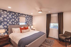 a bedroom with a bed and a chair in it at Sunset Cottage Hocking Hills in Rockbridge