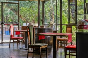 a restaurant with tables and chairs in front of a window at Parco del Paradosso in Viterbo +40 photos