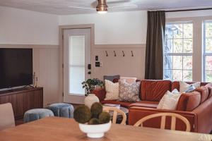 a living room with a couch and a table at Sunset Cottage Hocking Hills in Rockbridge