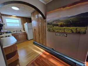a kitchen with a wall with a painting on it at Riverside Vista in Pulaski