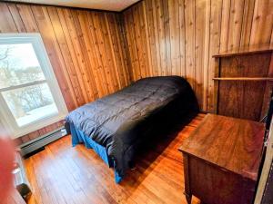 a bedroom with a bed and a wooden floor at Riverside Vista in Pulaski