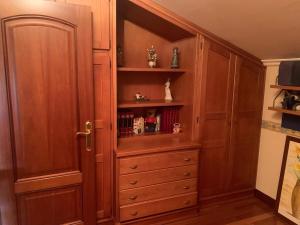 a large wooden cabinet in a room at Lar do Pero - Ribeira Sacra in Tioira