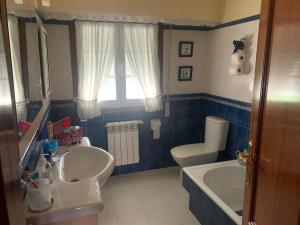 a bathroom with a sink and a toilet at Lar do Pero - Ribeira Sacra in Tioira +25 photos