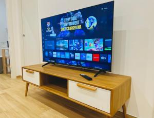 a flat screen tv sitting on top of a cabinet at Casa Genzino in Molfetta +87 photos