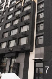a tall black and white building with a lot of windows at Мегаполис in Astana