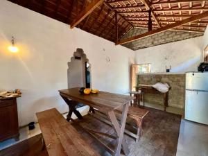 a kitchen with a wooden table in a room at Farmhouse Homestay in Negombo