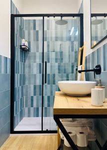 a bathroom with a sink and a glass shower at Casa Genzino in Molfetta