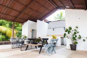 an outdoor patio with a table and chairs at Two-bedroom condo Ground floor in Santa Cruz Huatulco