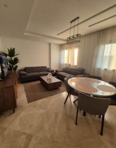 a living room with a table and a couch at You apparemment in Tangier