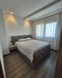 a bedroom with a large bed and a window at You apparemment in Tangier