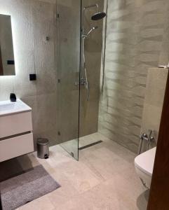 a bathroom with a shower and a toilet and a sink at You apparemment in Tangier