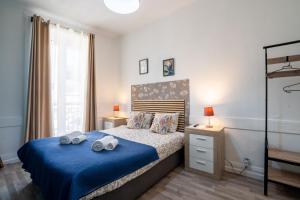 a bedroom with a bed with two towels on it at Madeirarooms in Funchal