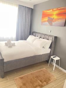 a bedroom with a large bed with white sheets at Naisolas place in Marimbeti