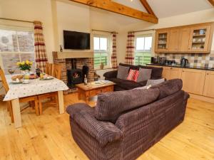 a living room with a couch and a table at West Gate in Embleton