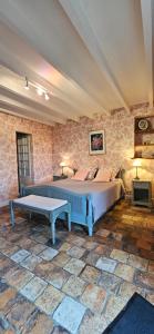 a bedroom with a bed and a table in a room at Moulin Notre Dame in Saint-Genès-de-Castillon +67 photos