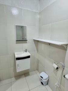 a white bathroom with a sink and a toilet at Casa com Piscina em Gravatá Carnaval in Gravatá +3 photos
