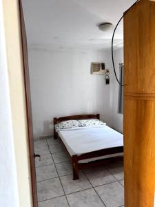 a bedroom with a bed in the corner of a room at Departamento Centrico 2B in Gualeguaychú +4 photos