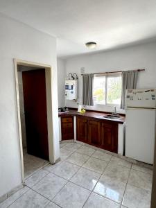 a kitchen with a white refrigerator and a window at Departamento Centrico 2B in Gualeguaychú