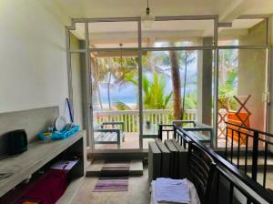 a room with a balcony with a view of the ocean at Villa Jesmin Home - Sea View in Habaraduwa Central