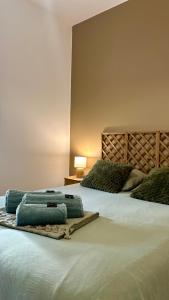 a bedroom with a large bed with white sheets at Casa Verde in Saint-Chamond