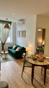 a living room with a couch and a table at Casa Verde in Saint-Chamond
