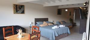 a bedroom with a bed and a table with a table sidx sidx sidx at ARWEN Suites 1 in Trevelín