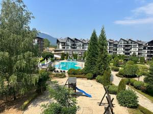 an apartment complex with a swimming pool and a resort at Aspen Golf Resort Studio E206 in Bansko
