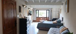 a bedroom with two beds and a living room at ARWEN Suites 1 in Trevelín
