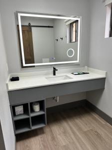 a bathroom with a sink and a large mirror at Ponderosa Lodge Ascend Collection in Red River