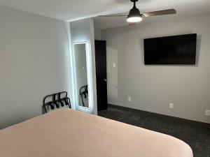 a dining room with a table and a flat screen tv at Ponderosa Lodge Ascend Collection in Red River