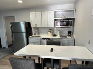 a kitchen with a refrigerator and a table with chairs at Ponderosa Lodge Ascend Collection in Red River
