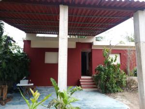 a red house with a red roof at Casa Corozo in Bacalar