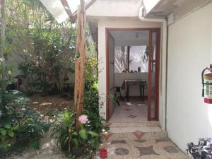 an open door to a house with plants at Casa Corozo in Bacalar +2 photos
